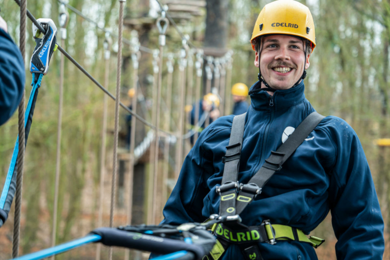A Sea Ranger in training at bootcamp. This Sea Ranger is a harness on a hire wire assault course.