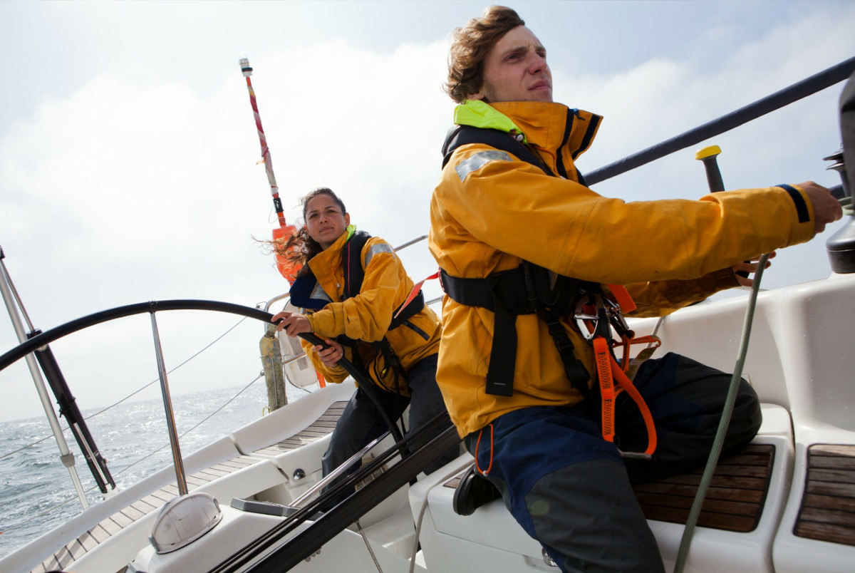 Two Sea Rangers out at sea, sailing. Both have safety equipment on. The weather is bright, and the ocean looks calm.