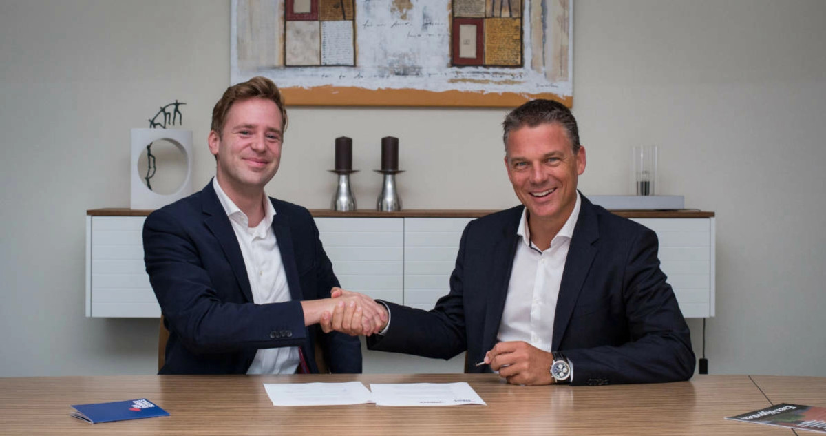 Wietse van der Werf, founder and CEO of Sea Ranger Service shakes hands with Koen van Swam, general manager of the North Sea Farm Foundation, over a signed contract.