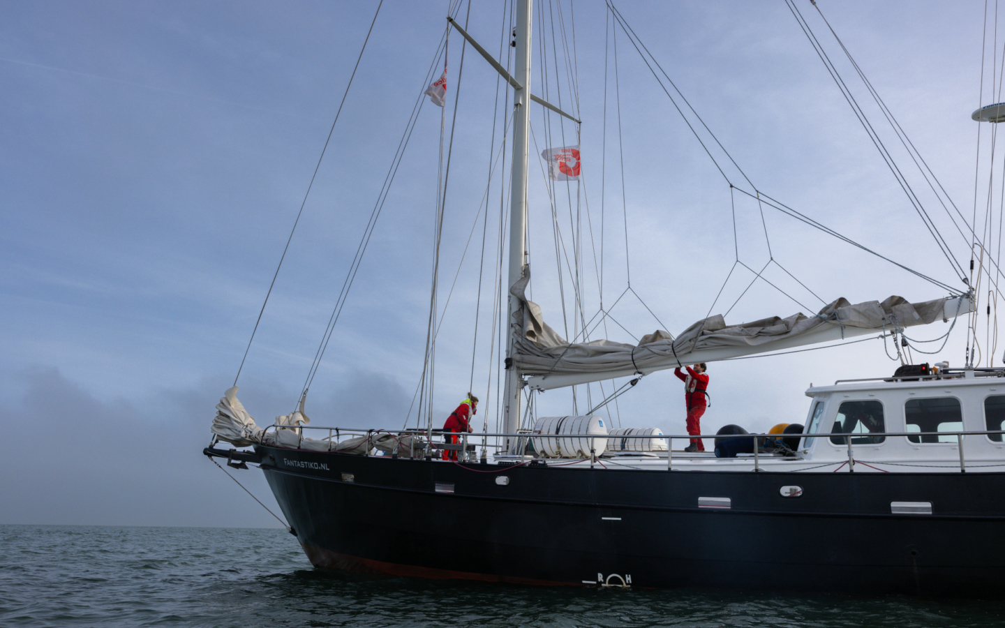 Sea Rangers on a ship at sea checking the sails and deck.