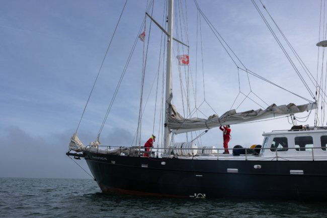 Sea Rangers on a ship at sea checking the sails and deck.